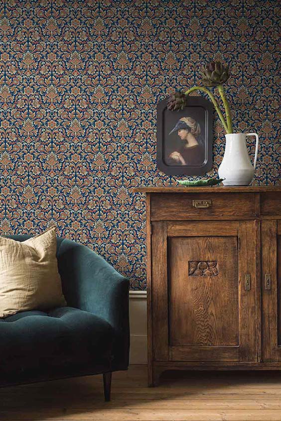 Old-money-aesthetic-living-room-with-demask-wallpaper-heavy-vintage-timber-sideboard-and-a-velvet-blue-armchair-1.jpg